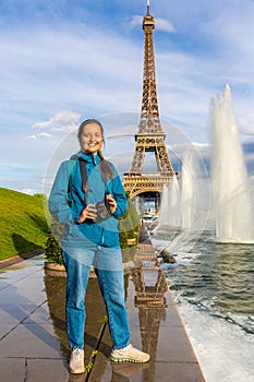 Woman traveler at Eiffel Tower and fountains of Trocadero in Paris, France