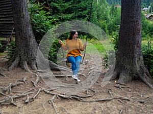 woman traveler enjoying of swinging on swing and mountain view