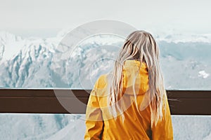 Woman traveler enjoying winter mountains landscape