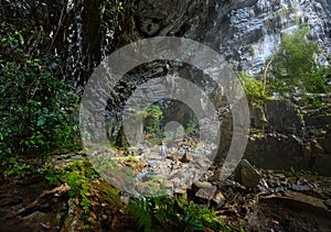 Woman traveler explores beautiful Hang Tien Cave in Phong Nha Ke National Park. Vietnam.