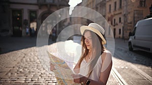 Woman traveler girl searching right direction on map, traveling along europe