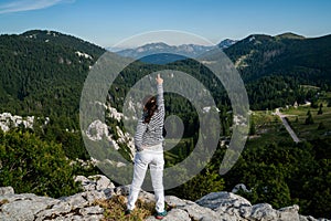 Woman traveler hiking across Croatia landscape.