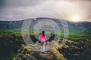 Woman traveler hiking across Iceland landscape.