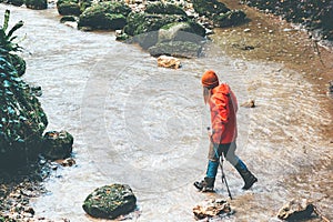 Woman Traveler hiking crossing stream