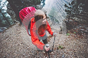 Woman Traveler hiking in foggy mountains