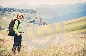 Woman Traveler hiking in Mountains