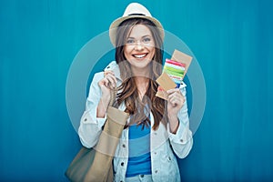 Woman traveler holding passport with ticket.