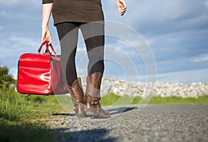 Woman traveler holding red bag