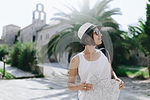 Woman traveler with map in old town