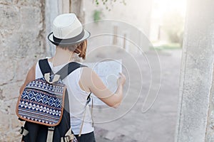 Woman traveler with map in old town