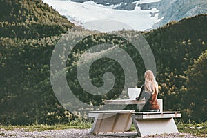 Woman traveler with map planning route trip in Norway sitting at the table Travel Lifestyle concept