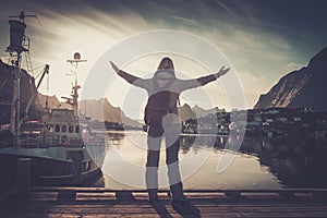 Woman traveler in Reine village with arms wide open