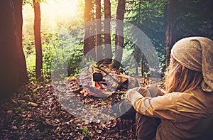 Woman traveler relaxing in forest and cooking food