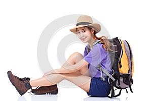 Woman traveler sitting on the floor with backpack