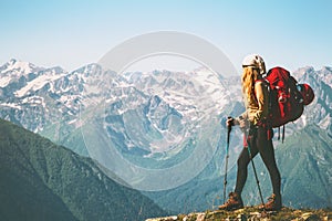 Woman Traveler standing on mountain cliff