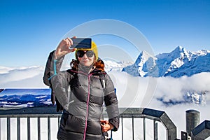 woman traveler in Swiss alps Jungfrau region taking pictures