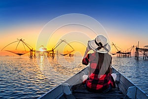 Woman traveler take a photo to fishing dip nets at Pakpra in Phatthalung, Thailand