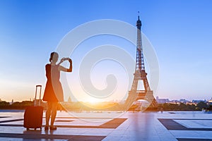 Woman traveler taking photo of Eiffel Tower from Trocadero