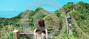 woman traveler visiting in Taiwan, Tourist with backpack sightseeing in Bitou Cape Hiking Trail, New Taipei City. landmark and