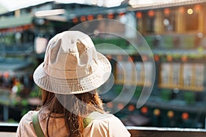 woman traveler visiting in Taiwan, Tourist with hat and backpack sightseeing in Jiufen Old Street village with Tea House