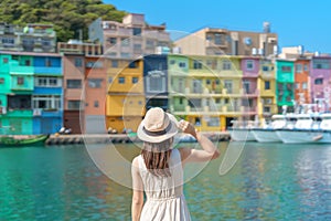 woman traveler visiting in Taiwan, Tourist with hat sightseeing in Keelung, Colorful Zhengbin Fishing Port, landmark and popular