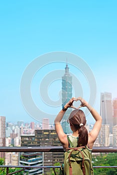 woman traveler visiting in Taiwan, Tourist looking Taipei City during sightseeing and hiking at Elephant Mountain or Xiangshan,