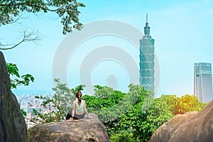 woman traveler visiting in Taiwan, Tourist looking Taipei City during sightseeing and hiking at Elephant Mountain or Xiangshan,