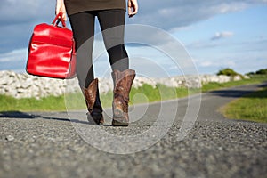 Woman traveler walking with red bag
