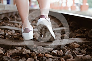 Woman traveler with white sneakers at train station. journey trip travel