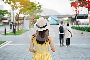 Woman Traveler with yellow dress visiting in Da Nang. Tourist sightseeing at love lock bridge. Landmark and popular. Vietnam and