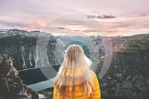 Woman traveling alone enjoying sunset mountains photo