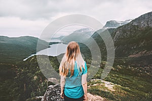 Woman traveling alone in moody mountains