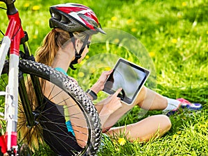 Woman traveling bicycle in summer park. Girl watch smart watch.