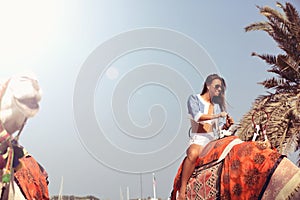 Woman traveling on camel.