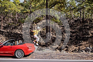Woman traveling by car in the mountain forest