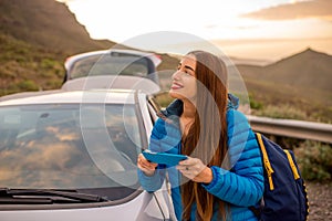 Woman traveling by car on the mountain road