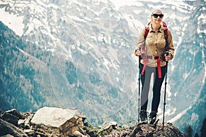 Woman traveling hiking with backpack at mountains