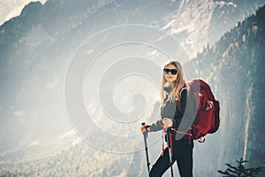 Woman traveling hiking with backpack at mountains