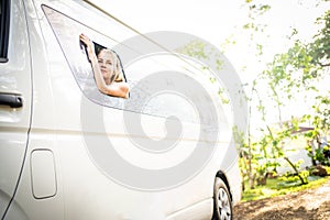 Woman traveling inside a van in the rainforest