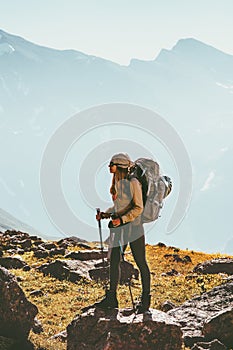 Woman traveling in mountains hiking with backpack