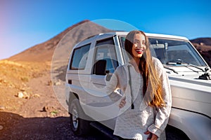 Woman traveling rocky landscape by jeep