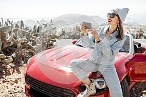 Woman traveling by sports car on the island