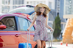 Woman traveling with suitcases,walking on the road