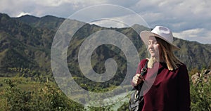 Woman traveller with map enjoying nature in mountains breathing fresh air.