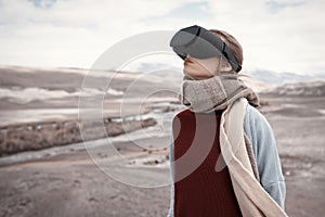 Woman travels in virtual reality. Wild nature