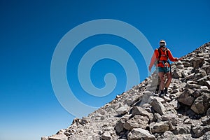 Woman Traverses the Last Rocky Stretch off the Summit of Lassen Peak