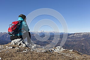 Woman trekker resting in mountains