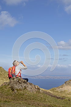 Woman trekking up to old man of storr on skye