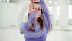 Woman in trendy colour sportswear doing stretch