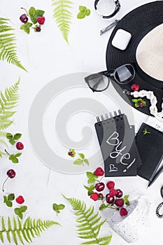 Woman trendy fashion clothes collage on white, flat lay, top view. Women`s accessories. Planning a vacation. Berries and leaves.